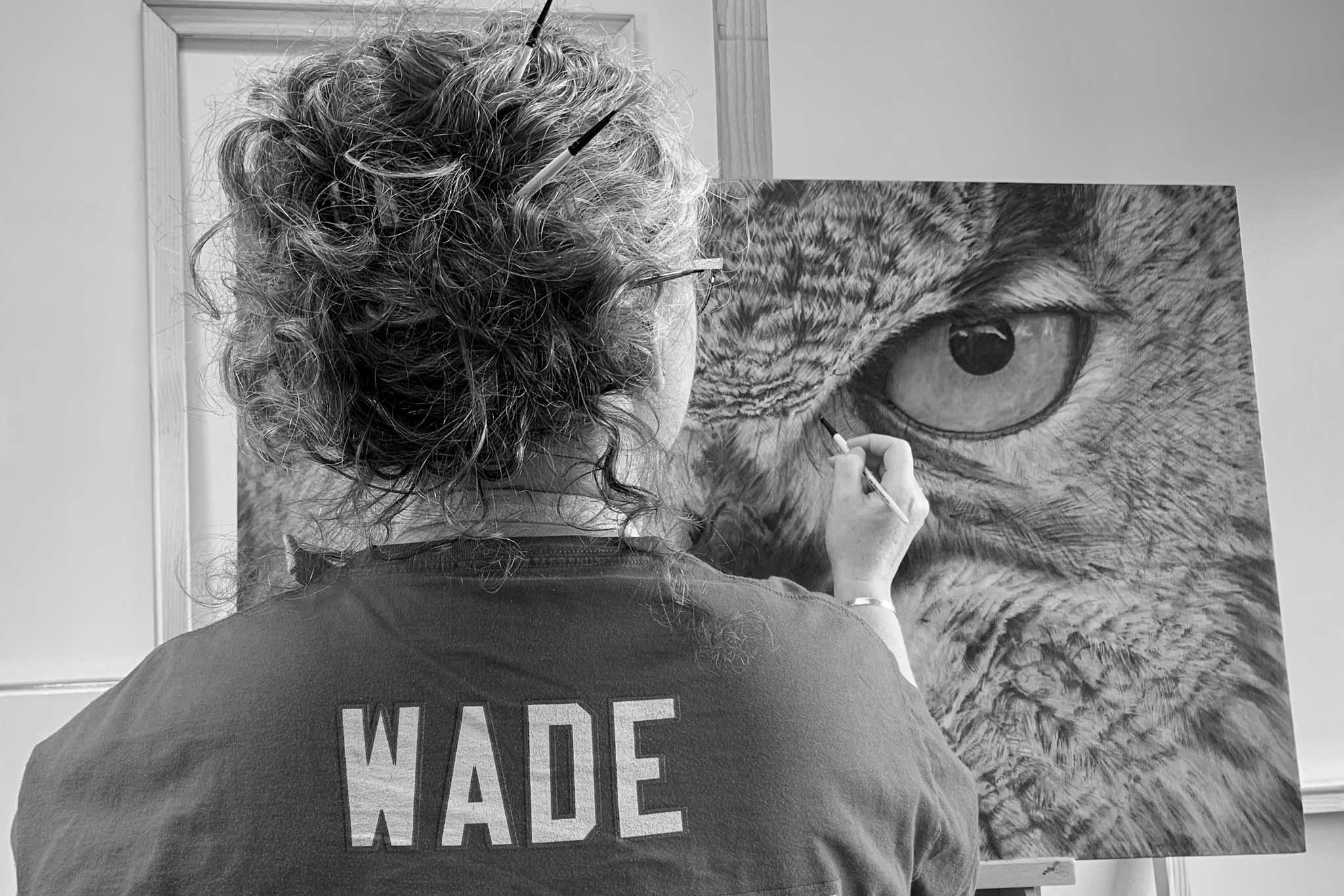 Karen Ryan painting an owl wearing Buffalo Bills Christian Wade jersey